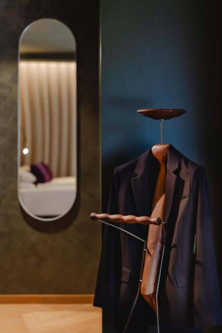 Design-Garderobe im Hotel nōa Schladming mit Spiegel und Blick ins Zimmer.
